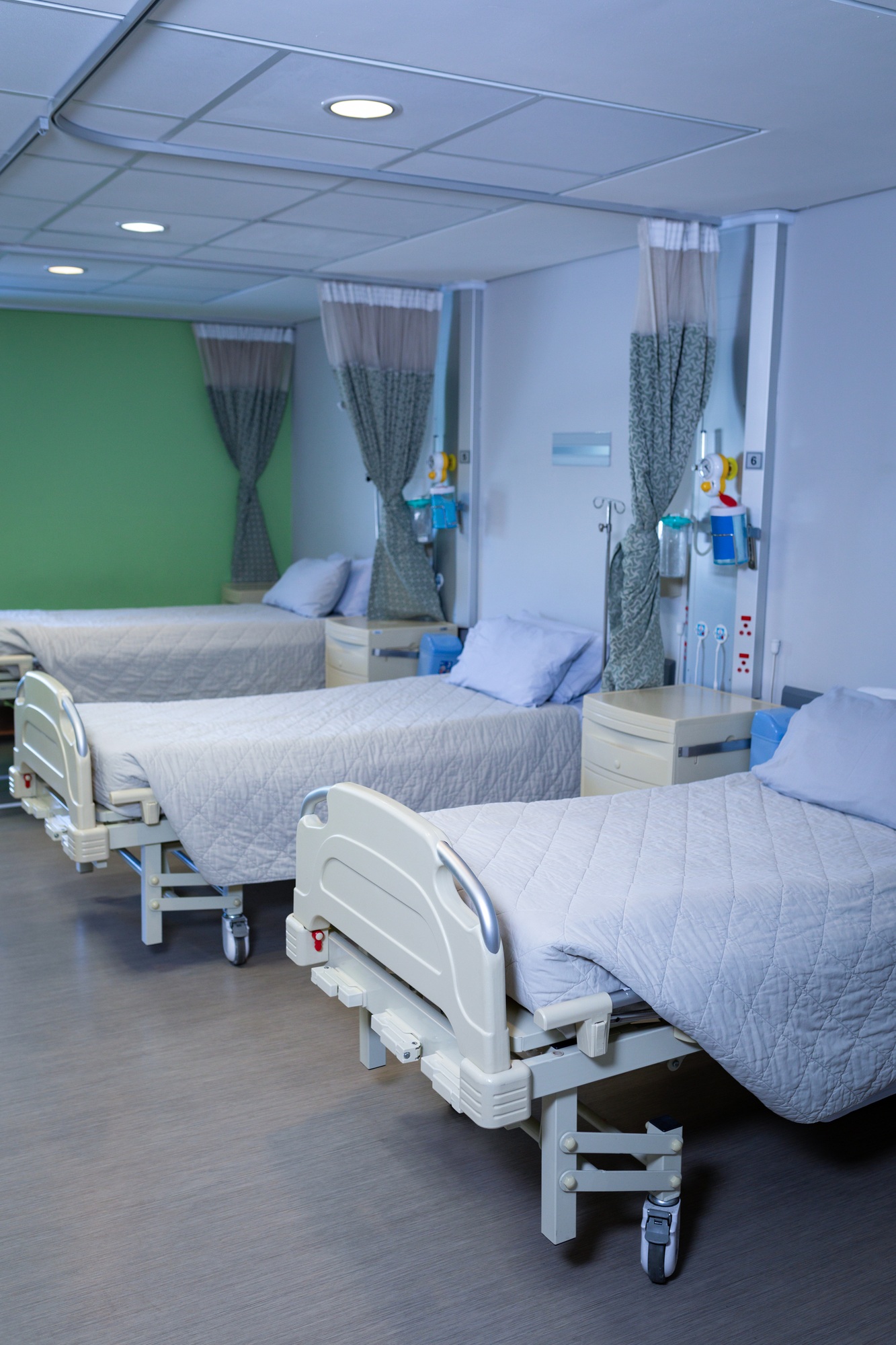 Front view of row of empty hospital beds in hospital